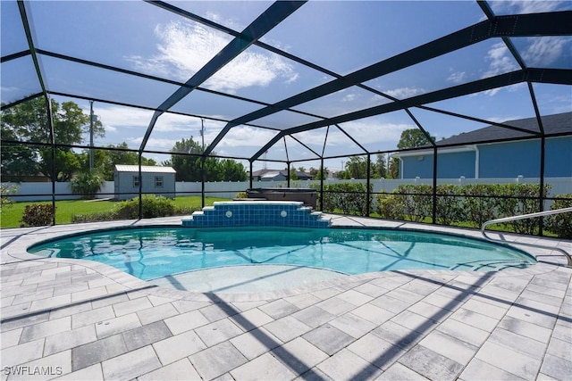 view of swimming pool featuring a lanai and a patio