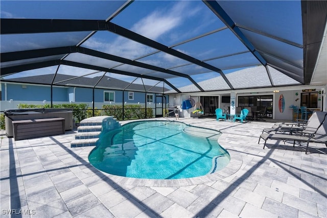 view of pool with a patio, a hot tub, and a lanai