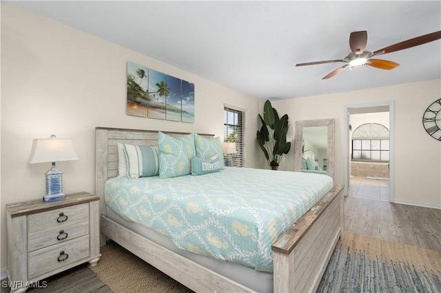 bedroom featuring connected bathroom, ceiling fan, and light wood-type flooring