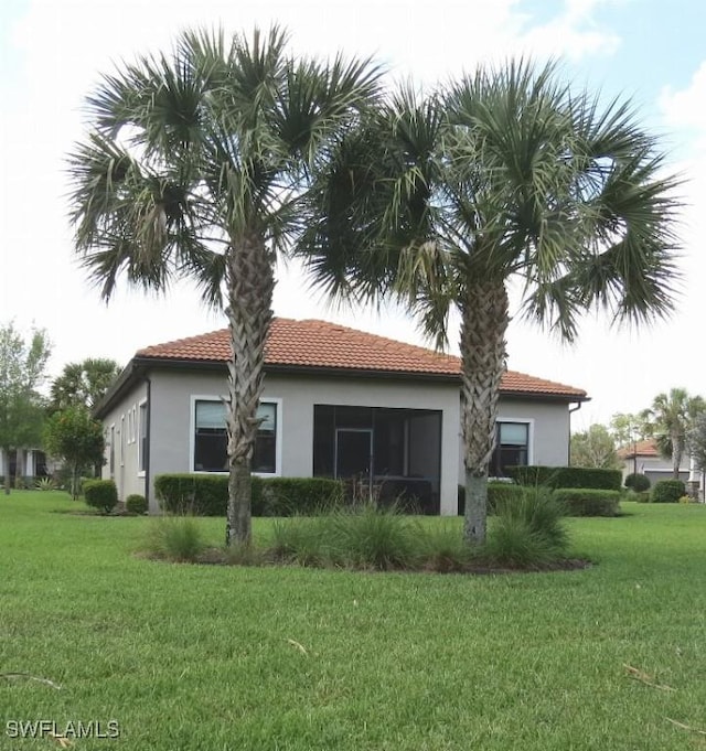 rear view of house with a yard