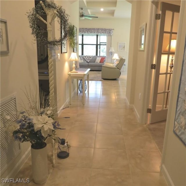 hall with tile patterned floors