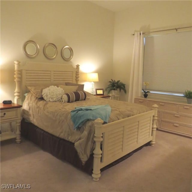 bedroom featuring light colored carpet