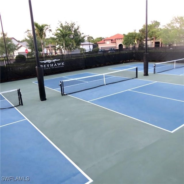 8874 Horned Lark Dr, Naples, FL 34120 - view of sport court featuring community basketball court and fence