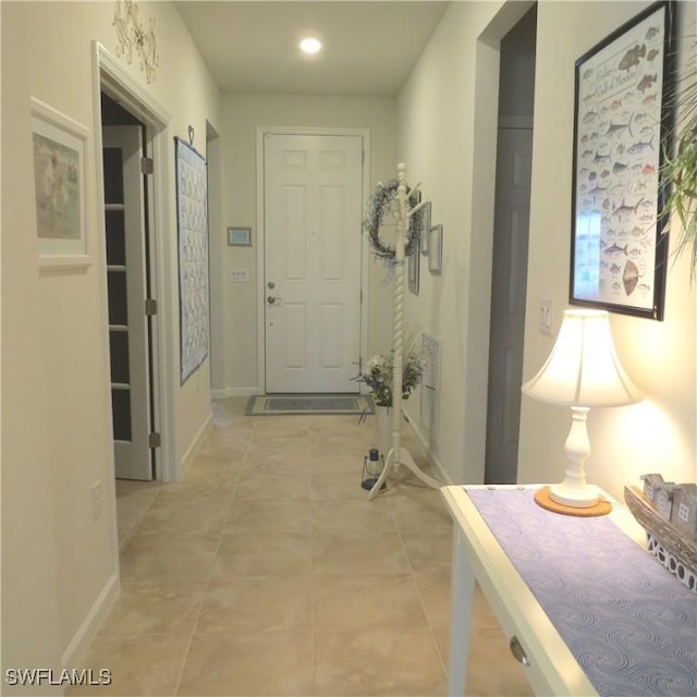 8874 Horned Lark Dr, Naples, FL 34120 - hallway featuring baseboards and light tile patterned flooring