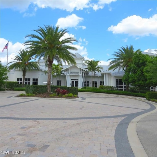 8874 Horned Lark Dr, Naples, FL 34120 - view of front facade featuring curved driveway