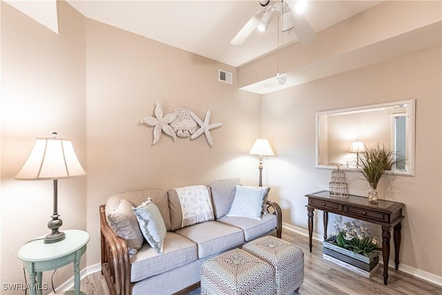 living room featuring ceiling fan and hardwood / wood-style flooring