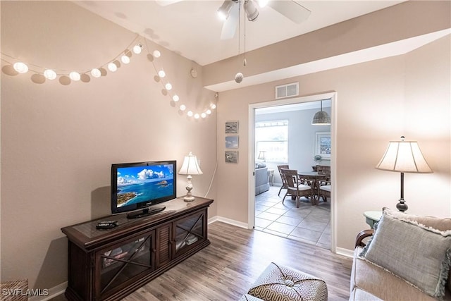 living room with hardwood / wood-style flooring and ceiling fan