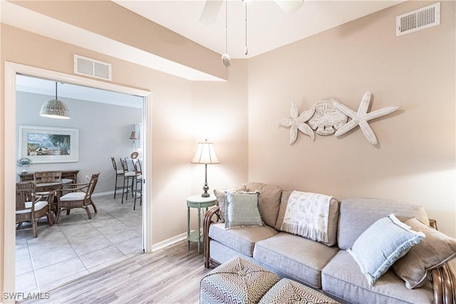 living room featuring ceiling fan and light tile patterned flooring