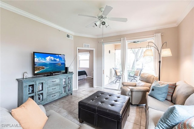 living room featuring ceiling fan, light tile patterned floors, and crown molding