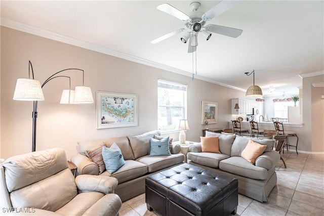 living room with ceiling fan, light tile patterned flooring, and crown molding