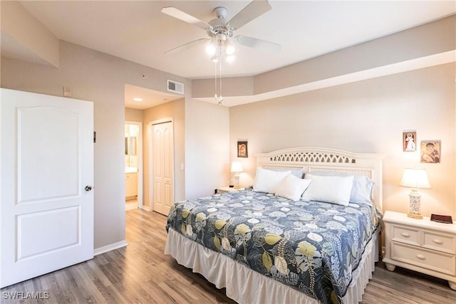 bedroom featuring hardwood / wood-style flooring, ceiling fan, and a closet