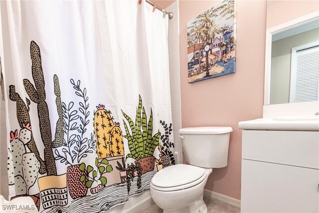 bathroom with vanity, toilet, and curtained shower