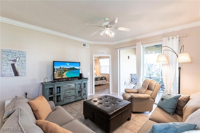 tiled living room with ornamental molding and ceiling fan