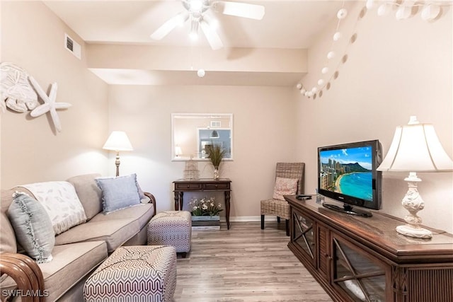 living room with ceiling fan and light wood-type flooring