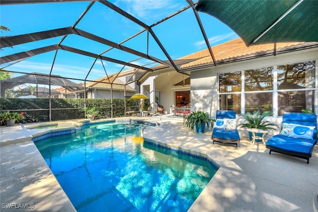 view of pool with glass enclosure and a patio area