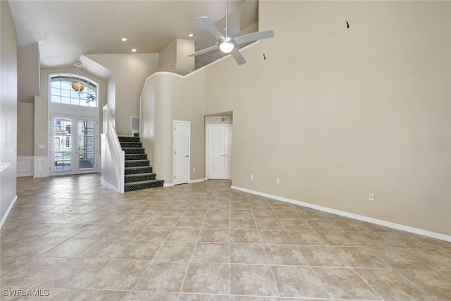 interior space with light tile patterned floors, high vaulted ceiling, and ceiling fan