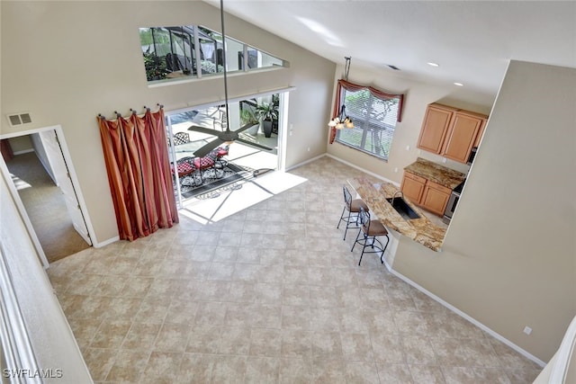 living room featuring sink and high vaulted ceiling