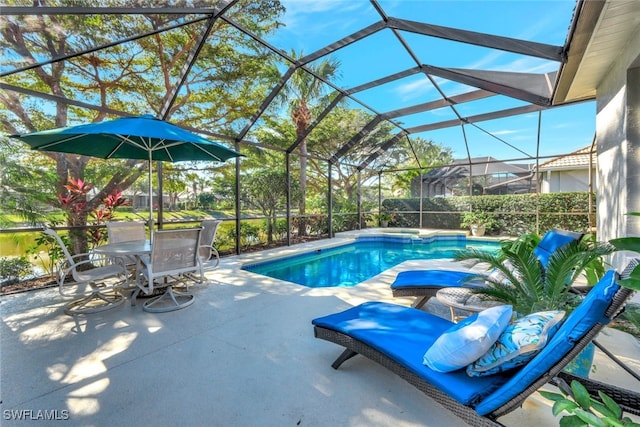 view of swimming pool with a patio area and glass enclosure