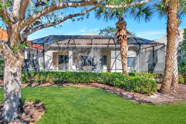 view of front of home with a lanai and a front yard