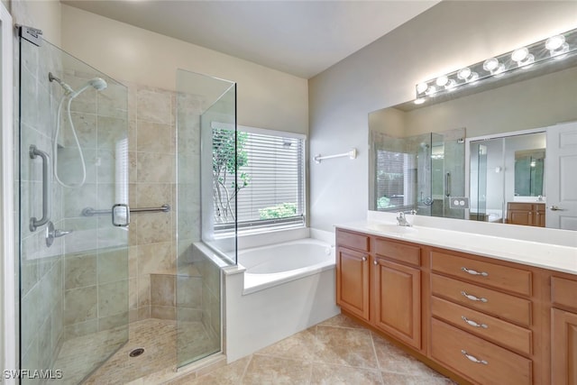 bathroom featuring shower with separate bathtub, tile patterned floors, and vanity