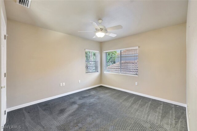 carpeted empty room featuring ceiling fan