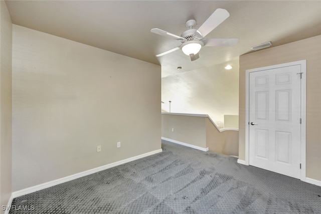 carpeted spare room featuring ceiling fan