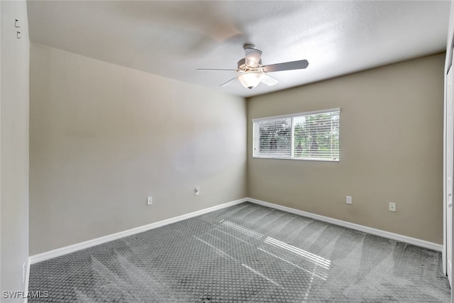 spare room with carpet floors and ceiling fan