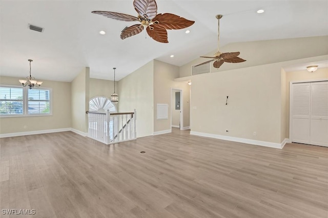 unfurnished living room featuring ceiling fan with notable chandelier, light hardwood / wood-style floors, lofted ceiling, and electric panel