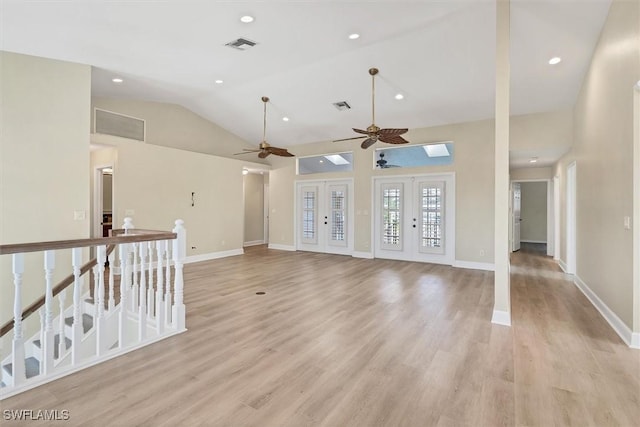 unfurnished living room featuring ceiling fan, light hardwood / wood-style floors, lofted ceiling, and french doors