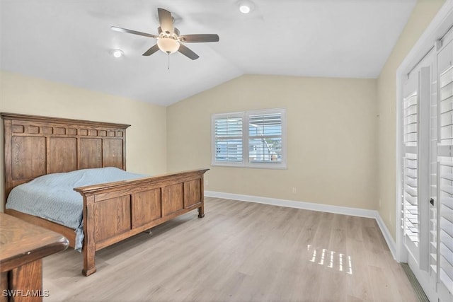 bedroom featuring ceiling fan, vaulted ceiling, and light wood-type flooring