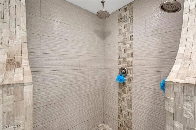 bathroom with a tile shower