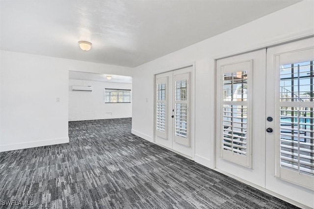 foyer featuring dark colored carpet, french doors, and a wall mounted AC