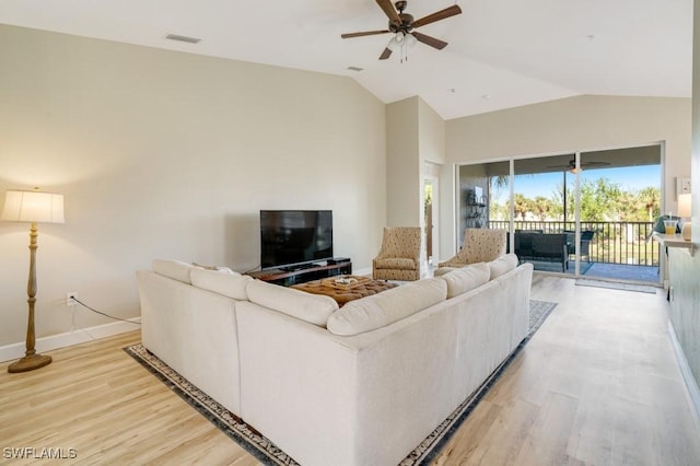 living room with ceiling fan, light hardwood / wood-style floors, and lofted ceiling