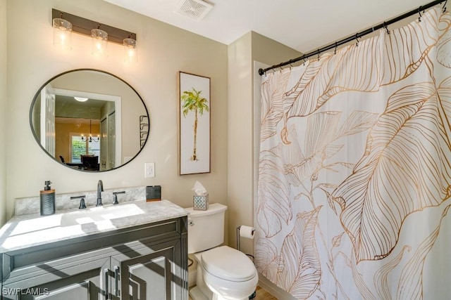 bathroom featuring vanity and toilet