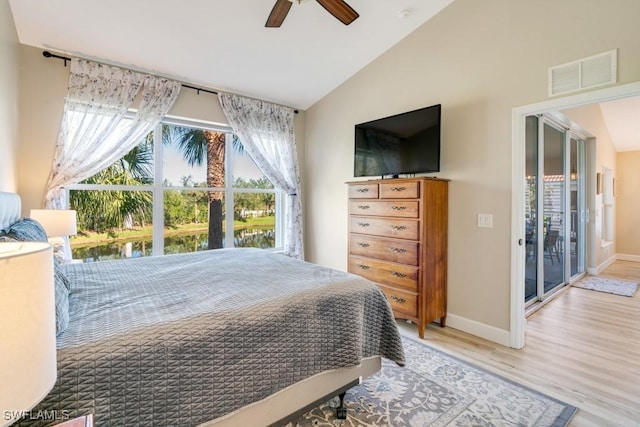 bedroom featuring hardwood / wood-style floors, ceiling fan, access to exterior, and lofted ceiling