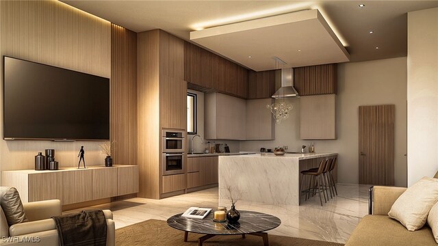 interior space with a kitchen breakfast bar, stainless steel double oven, and sink