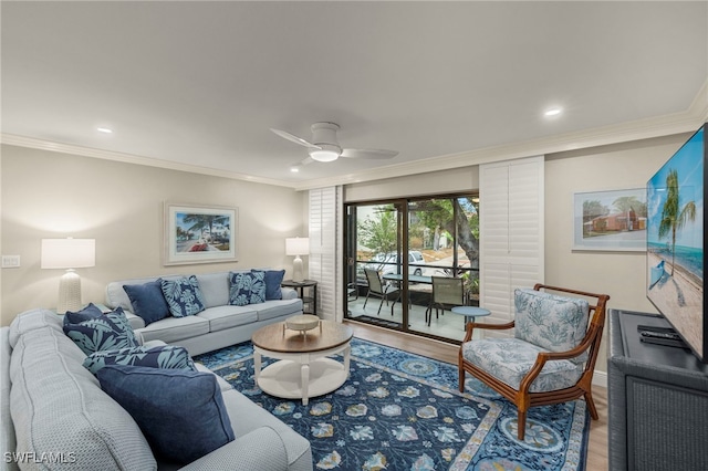 living room with ceiling fan, crown molding, and hardwood / wood-style floors