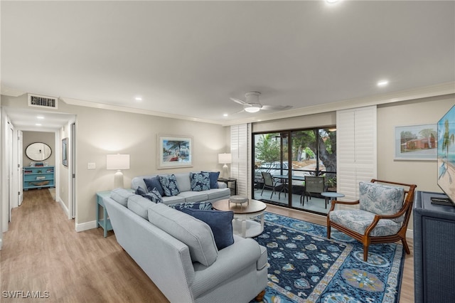 living room with ceiling fan, crown molding, and light hardwood / wood-style flooring