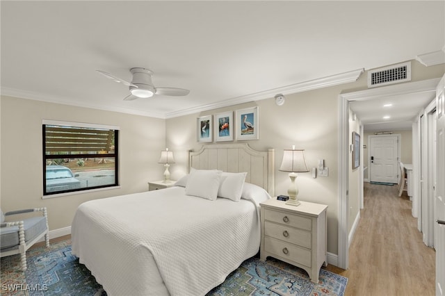 bedroom with ceiling fan, light hardwood / wood-style floors, and crown molding