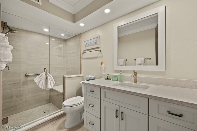 bathroom featuring toilet, vanity, hardwood / wood-style floors, crown molding, and an enclosed shower