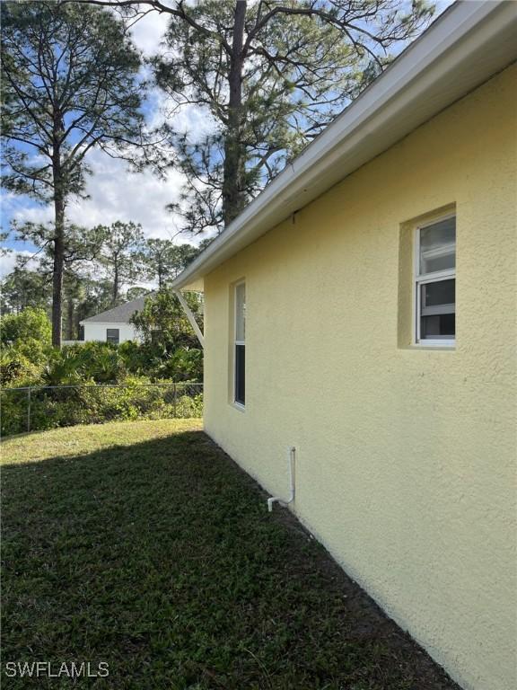 view of side of property with a lawn