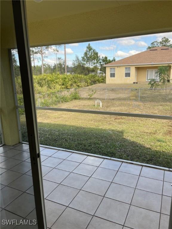 doorway to outside with tile patterned flooring