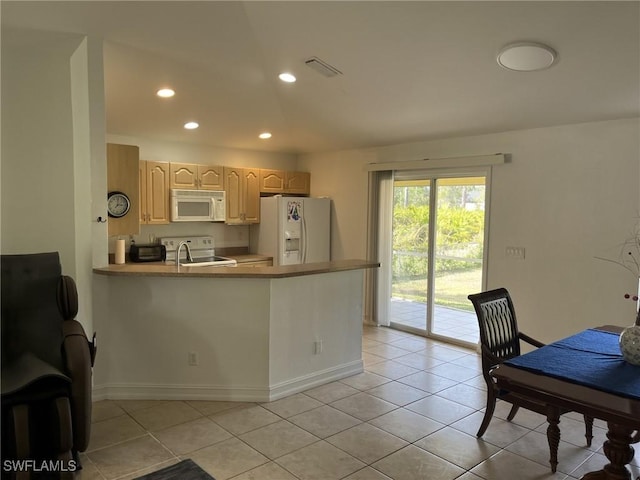 kitchen with white appliances, kitchen peninsula, light brown cabinetry, and light tile patterned floors