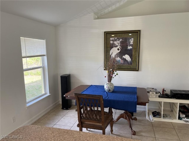 tiled dining room with vaulted ceiling