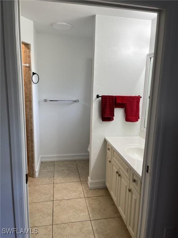 bathroom with toilet, tile patterned floors, and vanity