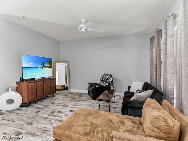 living room featuring light hardwood / wood-style floors and ceiling fan