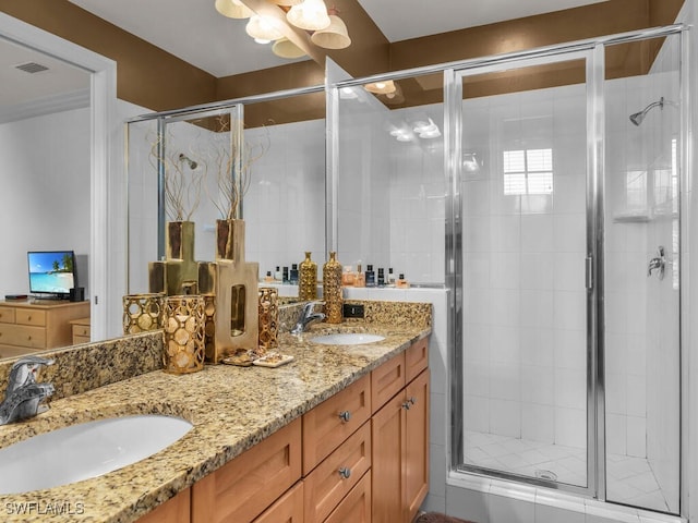 bathroom featuring vanity and an enclosed shower