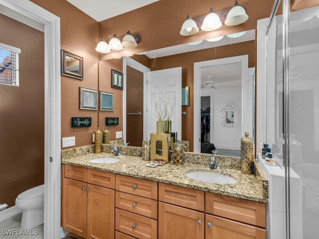 bathroom with vanity, tile patterned flooring, ceiling fan, toilet, and walk in shower