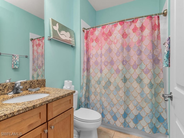 bathroom featuring tile patterned flooring, vanity, toilet, and walk in shower