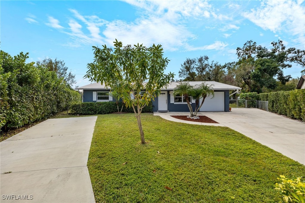 single story home featuring a garage and a front lawn